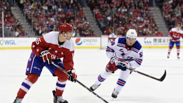 WASHINGTON, DC - FEBRUARY 24: Andre Burakovsky #65 of the Washington Capitals skates with the puck against Lias Andersson #50 of the New York Rangers in the third period at Capital One Arena on February 24, 2019 in Washington, DC. (Photo by Patrick McDermott/NHLI via Getty Images)