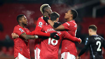 MANCHESTER, ENGLAND - JANUARY 01: Bruno Fernandes of Manchester United celebrates with teammates (L-R) Fred, Paul Pogba and Anthony Martial after scoring their team's second goal during the Premier League match between Manchester United and Aston Villa at Old Trafford on January 01, 2021 in Manchester, England. The match will be played without fans, behind closed doors as a Covid-19 precaution. (Photo by Carl Recine - Pool/Getty Images)