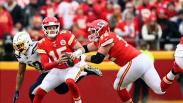 KANSAS CITY, MISSOURI - DECEMBER 29: Quarterback Patrick Mahomes #15 of the Kansas City Chiefs looks to pass as offensive tackle Eric Fisher #72 blocks linebacker Uchenna Nwosu #42 of the Los Angeles Chargers during the 1st quarter of the game at Arrowhead Stadium on December 29, 2019 in Kansas City, Missouri. (Photo by Jamie Squire/Getty Images)