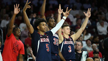 LOS ANGELES, CA - MARCH 01: Justin Kier #5, Christian Koloko #35 and Pelle Larsson #3 of the Arizona Wildcats celebrate after a three-point basket in the second half against the USC Trojans at Galen Center on March 1, 2022 in Los Angeles, California. (Photo by Jayne Kamin-Oncea/Getty Images)