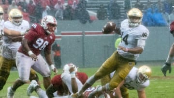 Oct 8, 2016; Raleigh, NC, USA; Notre Dame Fighting Irish quarterback DeShone Kizer (14) is pressured by North Carolina State Wolfpack defensive end Bradley Chubb (9) in the third quarter at Carter-Finley Stadium. NC State won 10-3. Mandatory Credit: Matt Cashore-USA TODAY Sports