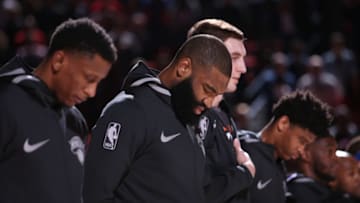 PORTLAND, OR - MARCH 6: Kyle O'Quinn #9 of the New York Knicks with his teammates stand for the National Anthem before the game against the Portland Trail Blazers on March 6, 2018 at the Moda Center in Portland, Oregon. Copyright 2018 NBAE (Photo by Sam Forencich/NBAE via Getty Images)
