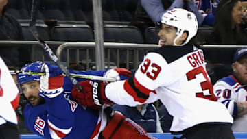 NEW YORK, NEW YORK - NOVEMBER 28: Vincent Trocheck #16 of the New York Rangers is checked by Ryan Graves #33 of the New Jersey Devils during the second period at Madison Square Garden on November 28, 2022 in New York City. (Photo by Bruce Bennett/Getty Images)