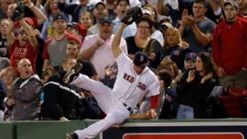 Jun 12, 2014; Boston, MA, USA; Boston Red Sox right fielder Grady Sizemore (38) catches the ball hit by Cleveland Indians third baseman Mike Aviles (not pictured) in foul territory as he falls into the stands during the fifth inning at Fenway Park. Mandatory Credit: Greg M. Cooper-USA TODAY Sports