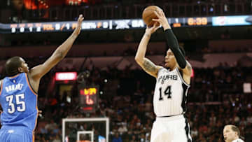May 10, 2016; San Antonio, TX, USA; San Antonio Spurs shooting guard Danny Green (14) shoots the ball over Oklahoma City Thunder small forward Kevin Durant (35) in game five of the second round of the NBA Playoffs at AT&T Center. Mandatory Credit: Soobum Im-USA TODAY Sports