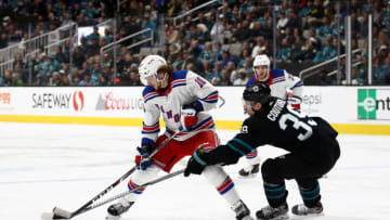SAN JOSE, CALIFORNIA - DECEMBER 12: Logan Couture #39 of the San Jose Sharks tries to get the puck from Artemi Panarin #10 of the New York Rangers at SAP Center on December 12, 2019 in San Jose, California. (Photo by Ezra Shaw/Getty Images)
