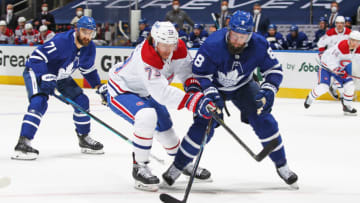 TORONTO, ON - MAY 22: Tyler Toffoli #73 of the Montreal Canadiens battles for the puck against Jake Muzzin #8 of the Toronto Maple Leafs in Game Two of the First Round of the 2021 Stanley Cup Playoffs at Scotiabank Arena on May 22, 2021 in Toronto, Ontario, Canada. The Maple Leafs defeated the Canadiens 5-1. (Photo by Claus Andersen/Getty Images)