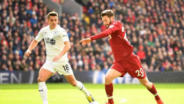 LIVERPOOL, ENGLAND - MARCH 10: Adam Lallana of Liverpool crosses under pressure from Ashley Westwood of Burnley during the Premier League match between Liverpool FC and Burnley FC at Anfield on March 10, 2019 in Liverpool, United Kingdom. (Photo by Michael Regan/Getty Images)