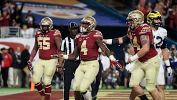 MIAMI GARDENS, FL - DECEMBER 30: Dalvin Cook #4 of the Florida State Seminoles celebrates his touchdown in the first quarter against the Michigan Wolverines during the Capitol One Orange Bowl at Sun Life Stadium on December 30, 2016 in Miami Gardens, Florida. (Photo by Mike Ehrmann/Getty Images)