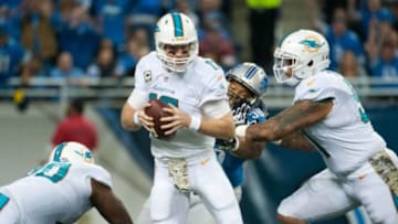 Nov 9, 2014; Detroit, MI, USA; Detroit Lions defensive tackle Ndamukong Suh (90) sacks Miami Dolphins quarterback Ryan Tannehill (17) during the first quarter at Ford Field. Mandatory Credit: Tim Fuller-USA TODAY Sports