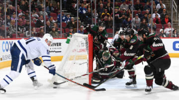 GLENDALE, ARIZONA - NOVEMBER 21: Jason Demers #55 and Nick Schmaltz #8 of the Arizona Coyotes attempt to clear the puck away from Zach Hyman #11 of the Toronto Maple Leafs during the third period at Gila River Arena on November 21, 2019 in Glendale, Arizona. (Photo by Norm Hall/NHLI via Getty Images)