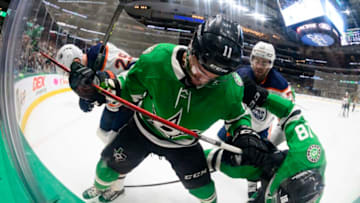 Mar 22, 2022; Dallas, Texas, USA; Dallas Stars left wing Michael Raffl (18) and center Luke Glendening (11) and Edmonton Oilers defenseman Evan Bouchard (75) and defenseman Darnell Nurse (25) battle for the puck during the second period at the American Airlines Center. Mandatory Credit: Jerome Miron-USA TODAY Sports