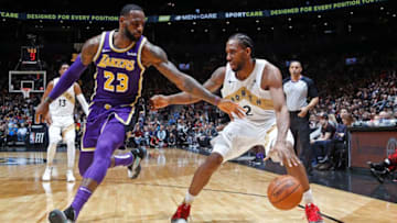 TORONTO, CANADA - MARCH 14: Kawhi Leonard #2 of the Toronto Raptors handles the ball against LeBron James #23 of the Los Angeles Lakers on March 14, 2019 at the Scotiabank Arena in Toronto, Ontario, Canada. NOTE TO USER: User expressly acknowledges and agrees that, by downloading and or using this Photograph, user is consenting to the terms and conditions of the Getty Images License Agreement. Mandatory Copyright Notice: Copyright 2019 NBAE (Photo by Mark Blinch/NBAE via Getty Images)