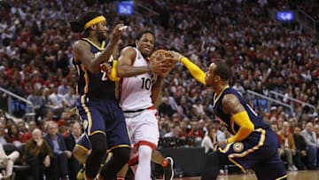 Apr 16, 2016; Toronto, Ontario, CAN; Toronto Raptors guard DeMar DeRozan (10) drives between Indiana Pacers center Jordan Hill (27) and guard Monta Ellis (11) in game one of the first round of the 2016 NBA Playoffs at Air Canada Centre. Indiana defeated Toronto 100-90. Mandatory Credit: John E. Sokolowski-USA TODAY Sports