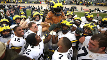 EAST LANSING, MI - OCTOBER 20: The Michigan Wolverines celebrate winning the Paul Bunyan trophy with a 21-7 win over the Michigan State Spartans at Spartan Stadium on October 20, 2018 in East Lansing, Michigan. (Photo by Gregory Shamus/Getty Images)