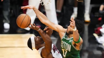 May 27, 2023; Miami, Florida, USA; Boston Celtics forward Jayson Tatum (0) fouls Miami Heat forward Jimmy Butler (22) in the fourth quarter during game six of the Eastern Conference Finals for the 2023 NBA playoffs at Kaseya Center. Mandatory Credit: Rich Storry-USA TODAY Sports
