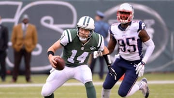Dec 27, 2015; East Rutherford, NJ, USA; New York Jets quarterback Ryan Fitzpatrick (14) runs the ball against New England Patriots defensive end Chandler Jones (95) at MetLife Stadium. Mandatory Credit: Robert Deutsch-USA TODAY Sports