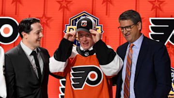 Jun 28, 2023; Nashville, Tennessee, USA; Philadelphia Flyers draft pick Matvei Michkov puts on his hat after being selected with the seventh pick in round one of the 2023 NHL Draft at Bridgestone Arena. Mandatory Credit: Christopher Hanewinckel-USA TODAY Sports