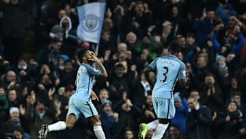 Manchester City's English midfielder Raheem Sterling (L) celebrates scoring his team's second goal during the English Premier League football match between Manchester City and Arsenal at the Etihad Stadium in Manchester, north west England, on December 18, 2016. / AFP / Oli SCARFF / RESTRICTED TO EDITORIAL USE. No use with unauthorized audio, video, data, fixture lists, club/league logos or 'live' services. Online in-match use limited to 75 images, no video emulation. No use in betting, games or single club/league/player publications. / (Photo credit should read OLI SCARFF/AFP/Getty Images)