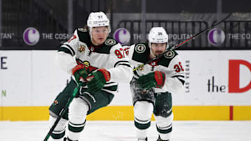 LAS VEGAS, NEVADA - MARCH 01: Kirill Kaprizov #97 of the Minnesota Wild carries the puck up the ice against the Vegas Golden Knights ahead of teammate Mats Zuccarello #36 in the third period of their game at T-Mobile Arena on March 1, 2021 in Las Vegas, Nevada. The Golden Knights defeated the Wild 5-4 in overtime. (Photo by Ethan Miller/Getty Images)
