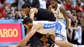 CHAPEL HILL, NORTH CAROLINA - JANUARY 12: Luke Maye #32 of the North Carolina Tar Heels battles Christen Cunningham #1 of the Louisville Cardinals for a loose ball during the second half of their game at the Dean Smith Center on January 12, 2019 in Chapel Hill, North Carolina. Louisville won 83-62. (Photo by Grant Halverson/Getty Images)
