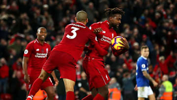 LIVERPOOL, ENGLAND - DECEMBER 02: Divock Origi of Liverpool celebrates with teammate Fabinho after scoring his team's first goal during the Premier League match between Liverpool FC and Everton FC at Anfield on December 2, 2018 in Liverpool, United Kingdom. (Photo by Clive Brunskill/Getty Images)