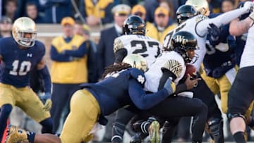 Nov 14, 2015; South Bend, IN, USA; Wake Forest Demon Deacons quarterback Kendall Hinton (2) is sacked by Notre Dame Fighting Irish defensive lineman Sheldon Day (91) in the second quarter at Notre Dame Stadium. Notre Dame won 28-7. Mandatory Credit: Matt Cashore-USA TODAY Sports