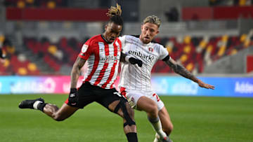 BRENTFORD, ENGLAND - APRIL 27: Ivan Toney of Brentford shoots and misses whilst under pressure from Angus MacDonald of Rotherham United during the Sky Bet Championship match between Brentford and Rotherham United at Brentford Community Stadium on April 27, 2021 in Brentford, England. Sporting stadiums around the UK remain under strict restrictions due to the Coronavirus Pandemic as Government social distancing laws prohibit fans inside venues resulting in games being played behind closed doors. (Photo by Justin Setterfield/Getty Images)