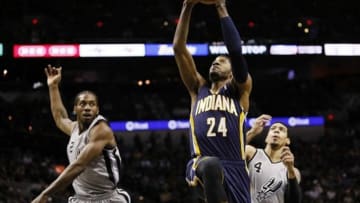 Dec 7, 2013; San Antonio, TX, USA; Indiana Pacers forward Paul George (24) drives to the basket as San Antonio Spurs forward Kawhi Leonard (2) and guard Danny Green (4) look on during the first half at AT
