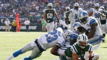 Sep 28, 2014; East Rutherford, NJ, USA; New York Jets wide receiver Eric Decker (87) scores a touchdown as Detroit Lions cornerback Darius Slay (23), middle linebacker Stephen Tulloch (55), and strong safety James Ihedigbo (32) defend in the third quarter at MetLife Stadium. Mandatory Credit: Noah K. Murray-USA TODAY Sports