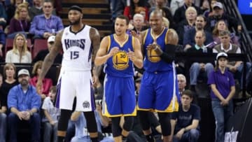 Feb 3, 2015; Sacramento, CA, USA; Golden State Warriors guard Stephen Curry (30) and center Marreese Speights (5) reacts after forcing a travel against Sacramento Kings center DeMarcus Cousins (15) during the first quarter at Sleep Train Arena. Mandatory Credit: Kelley L Cox-USA TODAY Sports