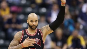 Mar 21, 2014; Indianapolis, IN, USA; Chicago Bulls forward Carlos Boozer (5) raises his hand after being called for a foul playing against the Indiana Pacers at Bankers Life Fieldhouse. Indiana defeats Chicago 91-79. Mandatory Credit: Brian Spurlock-USA TODAY Sports