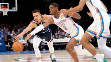 Nuggets forward Michael Porter Jr. (1) and OKC Thunder guard Shai Gilgeous-Alexander (2) reach for a loose ball : Alonzo Adams-USA TODAY Sports