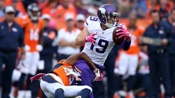 DENVER, CO - OCTOBER 04: Wide receiver Adam Thielen #19 of the Minnesota Vikings makes a reception and is tackled by cornerback Chris Harris #25 of the Denver Broncos at Sports Authority Field at Mile High on October 4, 2015 in Denver, Colorado. The Broncos defeated the Vikings 23-20. (Photo by Doug Pensinger/Getty Images)