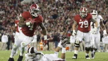 Nov 15, 2014; Tuscaloosa, AL, USA; Alabama Crimson Tide running back T.J. Yeldon (4) carries the past Mississippi State Bulldogs defensive back Justin Cox (9) for a touchdown in the fourth quarter at Bryant-Denny Stadium. Mandatory Credit: Marvin Gentry-USA TODAY Sports