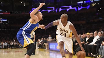 Mar 6, 2016; Los Angeles, CA, USA; Los Angeles Lakers forward Kobe Bryant (24) is defended by Golden State Warriors guard Stephen Curry (30) during the NBA game at the Staples Center. Mandatory Credit: Richard Mackson-USA TODAY Sports