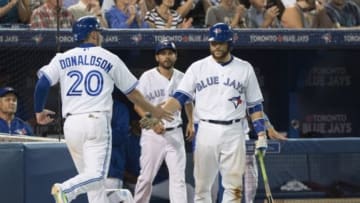 Jul 31, 2015; Toronto, Ontario, CAN; Toronto Blue Jays third baseman Josh Donaldson (20) celebrates scoring a run with catcher Russell Martin (55) during the eighth inning in a game against the Kansas City Royals at Rogers Centre. The Toronto Blue Jays won 7-6. Mandatory Credit: Nick Turchiaro-USA TODAY Sports