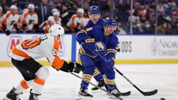 Jan 22, 2022; Buffalo, New York, USA; Buffalo Sabres defenseman Jacob Bryson (78) makes a pass as Philadelphia Flyers center Gerry Mayhew (20) defends during the second period at KeyBank Center. Mandatory Credit: Timothy T. Ludwig-USA TODAY Sports