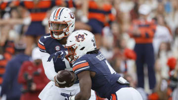 Auburn footballNov 27, 2021; Auburn, Alabama, USA; Auburn Tigers quarterback TJ Finley (1) hands off to running back Tank Bigsby (4) during the first quarter against the Alabama Crimson Tide at Jordan-Hare Stadium. Mandatory Credit: John Reed-USA TODAY Sports