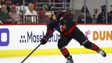 RALEIGH, NORTH CAROLINA - JUNE 08: Dougie Hamilton #19 of the Carolina Hurricanes skates with the puck during the first period in Game Five of the Second Round of the 2021 Stanley Cup Playoffs against the Tampa Bay Lightning at PNC Arena on June 08, 2021 in Raleigh, North Carolina. (Photo by Jared C. Tilton/Getty Images)