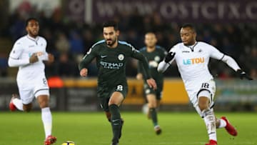 SWANSEA, WALES - DECEMBER 13: Ilkay Gundogan of Manchester City is tracked by Jordan Ayew of Swansea City during the Premier League match between Swansea City and Manchester City at Liberty Stadium on December 13, 2017 in Swansea, Wales. (Photo by Michael Steele/Getty Images)