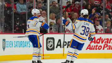 Nov 4, 2022; Raleigh, North Carolina, USA; Buffalo Sabres left wing Victor Olofsson (71) is congratulated by defenseman Kale Clague (38) after his goal against the Carolina Hurricanes during the first period at PNC Arena. Mandatory Credit: James Guillory-USA TODAY Sports