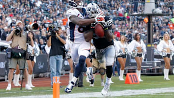 Nov 9, 2014; Oakland, CA, USA; Oakland Raiders cornerback D.J. Hayden (25) breaks up a pass intended for Denver Broncos wide receiver Demaryius Thomas (88) in the third quarter at O.co Coliseum. The Broncos defeated the Raiders 41-17. Mandatory Credit: Cary Edmondson-USA TODAY Sports