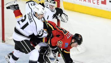 Apr 5, 2016; Calgary, Alberta, CAN; Calgary Flames center Sam Bennett (93) gets tripped up by Los Angeles Kings center Nick Shore (21) at Scotiabank Saddledome. Kings won 5-4 in overtime. Mandatory Credit: Candice Ward-USA TODAY Sports