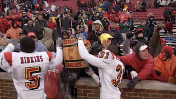 NOV. 28 2003: Louisville players Josh Minkins and J.T. Haskins carried the keg of nails trophy to the sidelines for the U of L fans after defeating Cincinnati.Title Minkins Haskins