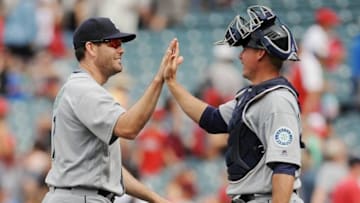 April 24, 2016; Anaheim, CA, USA; Seattle Mariners right fielder Seth Smith (7) and catcher Steve Clevenger (32) celebrate the 9-4 victory against Los Angeles Angels at Angel Stadium of Anaheim. Mandatory Credit: Gary A. Vasquez-USA TODAY Sports