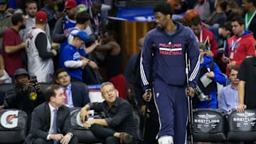 Nov 2, 2015; Philadelphia, PA, USA; Philadelphia 76ers general manager Sam Hinkie (far left) watches as center Joel Embiid (21) walks out of the tunnel on crutches prior to a game against the Cleveland Cavaliers at Wells Fargo Center. Mandatory Credit: Bill Streicher-USA TODAY Sports