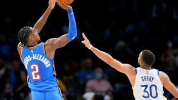 OKC Thunder guard Shai Gilgeous-Alexander (2) shoots over Golden State's Stephen Curry (30) on Oct. 26 at Paycom Center.jump
