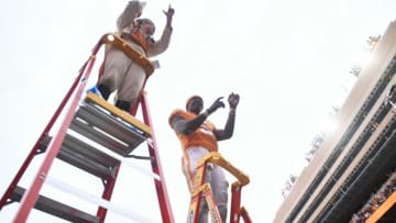 Tennessee quarterback Hendon Hooker (5), with help from drum major Julia Boylan, leads the Pride of the Southland Band in the playing of Rocky Top after Tennessee's win over Missouri in the NCAA college football game on Saturday, November 12, 2022 in Knoxville, Tenn.Ut Vs Missouri