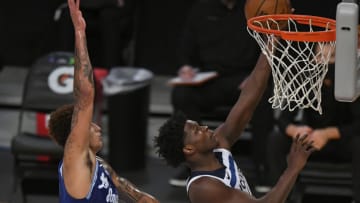 Kyle Kuzma of the Los Angeles Lakers goes up to block a shot by Anthony Edwards of the Minnesota Timberwolves. (Photo by John McCoy/Getty Images)